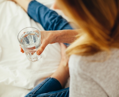 hand holding a glass of water